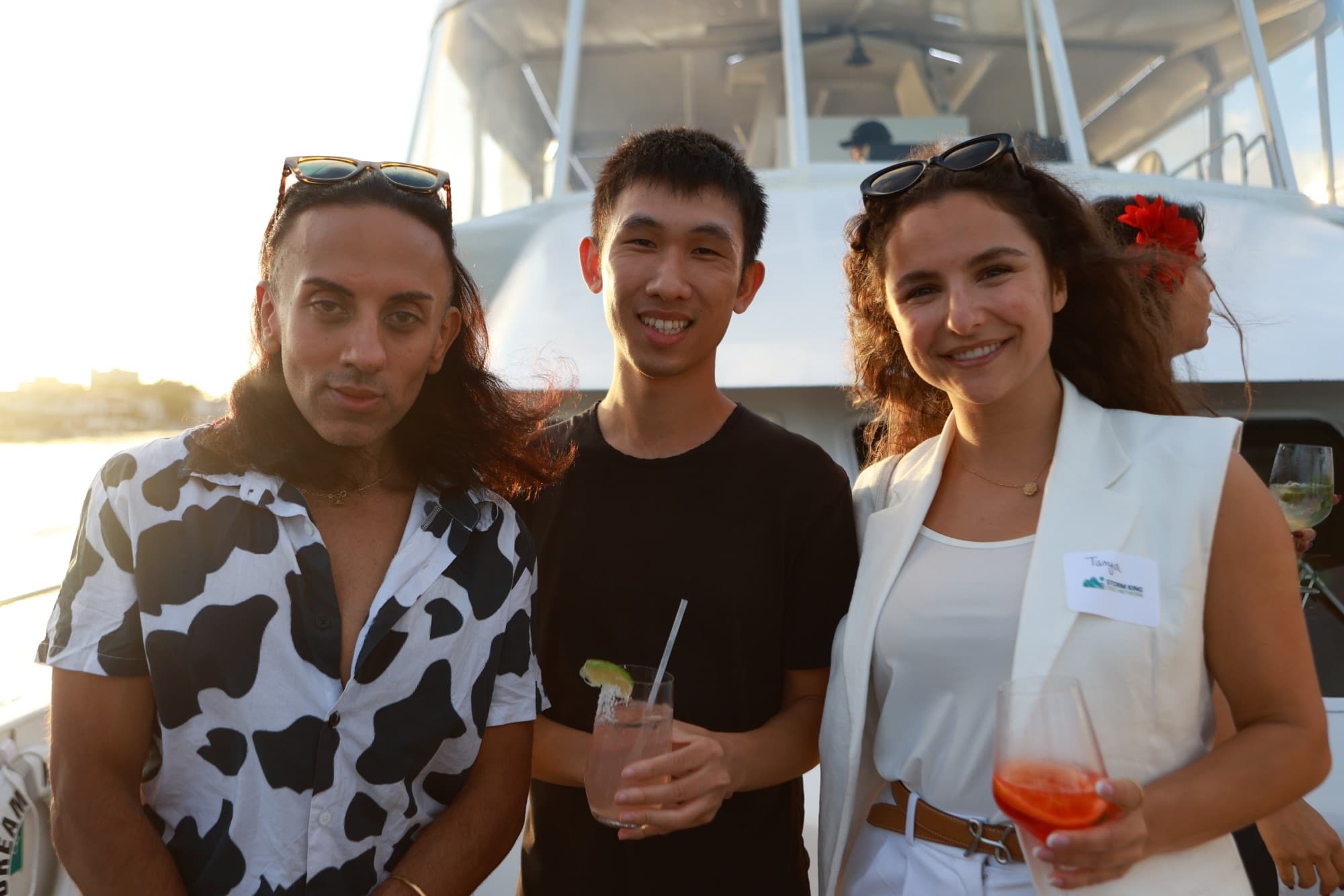 Guests with drinks aboard the boat at a Chord community event